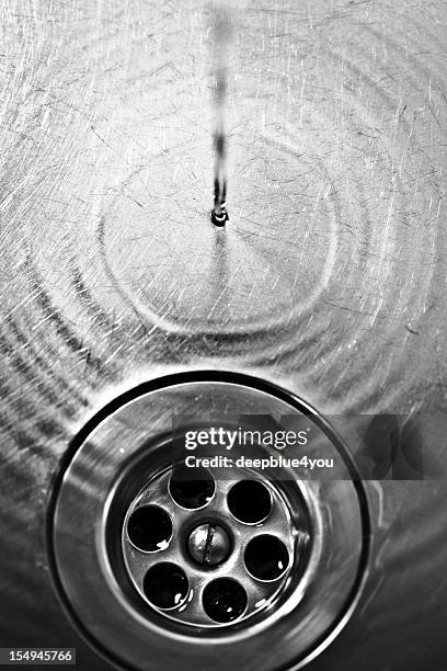 dark drain with water - kitchen sink running water stock pictures, royalty-free photos & images