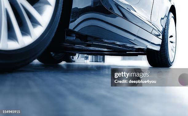 sharp focus ground view of modern blue car - car underside stock pictures, royalty-free photos & images