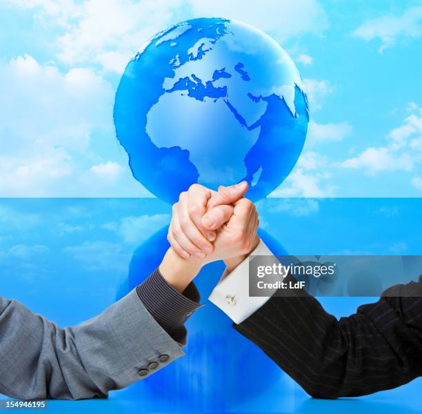 arm wrestling against globe - europe, africa and middle east - conflict resolution stock pictures, royalty-free photos & images