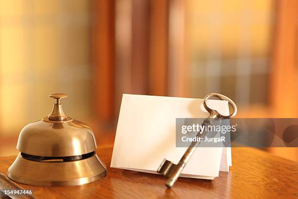 service bell, old fashioned door key and card in hotel lobby - hotel key stock pictures, royalty-free photos & images