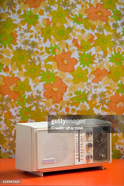 vintage 60's 70's clock radio with floral wallpaper background orange - orange alarm clock stock pictures, royalty-free photos & images