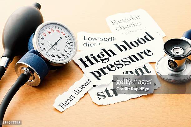 blood pressure gauge, stethoscope and hypertension headlines - risk meter stock pictures, royalty-free photos & images