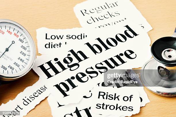 close up on high blood pressure headlines with medical instruments - high blood pressure stockfoto's en -beelden