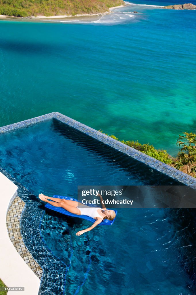 Infinity Pool Raft Blond Woman In Infinity Pool Floating On A Raft High-Res Stock Photo ...