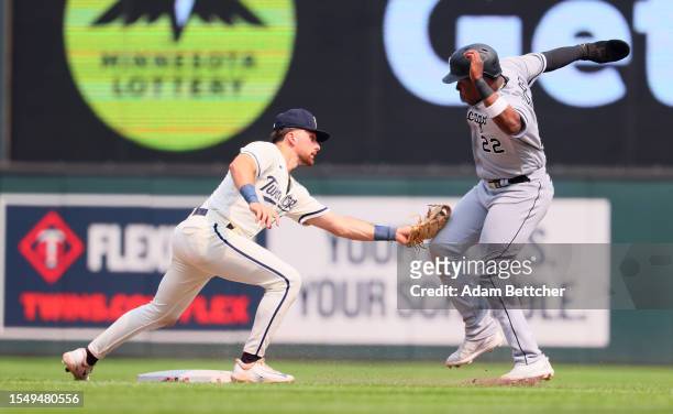 Edouard Julien of the Minnesota Twins makes the catch and tag on Oscar Colas of the Chicago White Sox in the ninth inning at Target Field on July 23,...