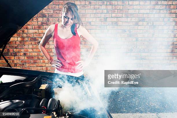 car trouble! worried girl with smoking automobile engine - overheated stock pictures, royalty-free photos & images