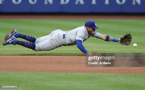Miguel Rojas of the Los Angeles Dodgers cannot get to a ground ball against the New York Mets during their game at Citi Field in the Queens borough...