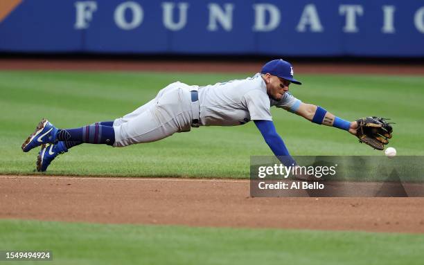 Miguel Rojas of the Los Angeles Dodgers cannot get to a ground ball against the New York Mets during their game at Citi Field in the Queens borough...