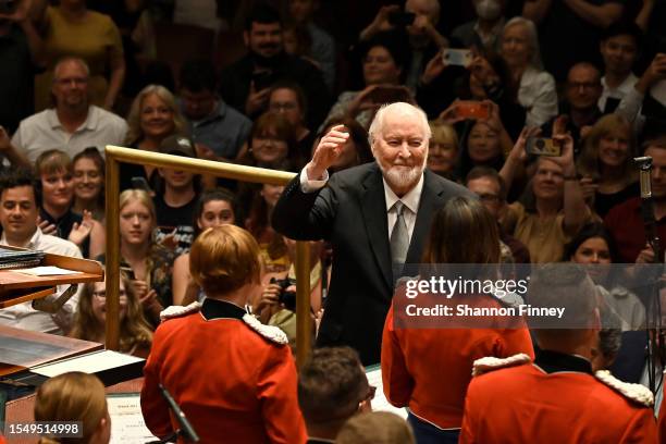 The audience and performers welcome composer John Williams to the stage at a concert celebrating the 225th anniversary of "The President's Own"...