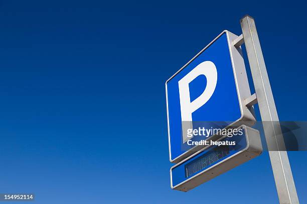 blue and white parking sign over blue sky - parking sign stock pictures, royalty-free photos & images