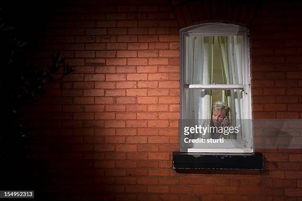 vulnerable pensioner - peep window stock pictures, royalty-free photos & images