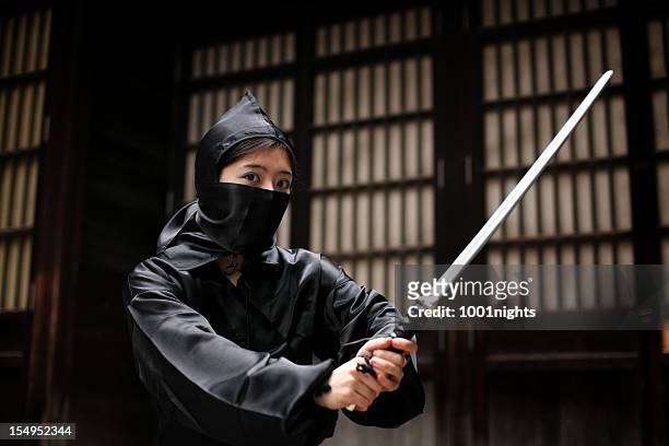 asian woman showing her ninja moves - ninja weapon stock pictures, royalty-free photos & images