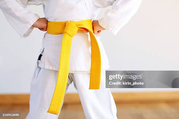 karate uniform - yellow belt stock pictures, royalty-free photos & images