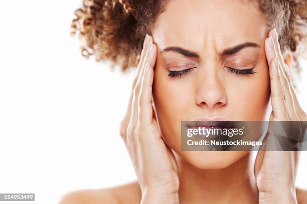 attractive young woman rubbing her temples - rub temples stock pictures, royalty-free photos & images