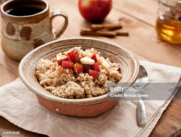 breakfast made of oatmeal with apples, honey and cinnamon  - oatmeal stock pictures, royalty-free photos & images