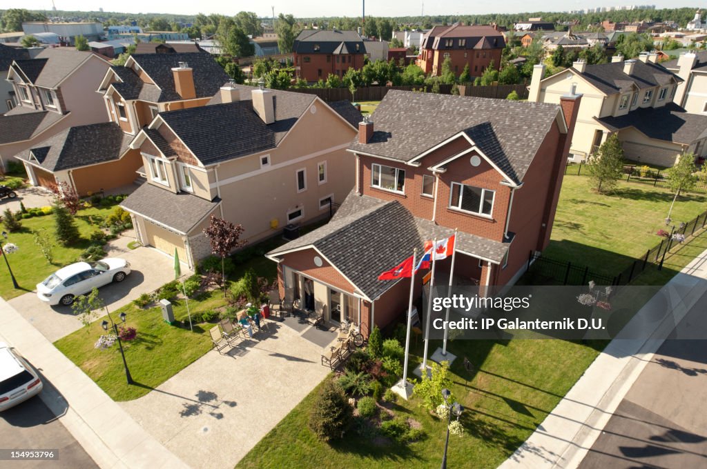 People sitting in front of their brand new home.