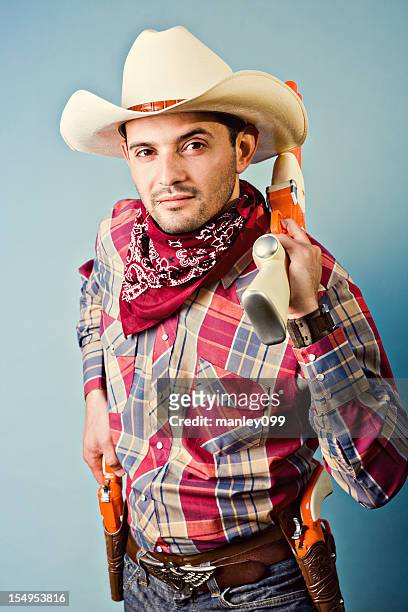 cowboy with toy shotgun and revolvers - rodeo background stock pictures, royalty-free photos & images