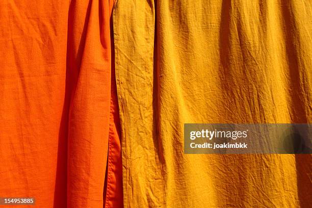 saffron fabric used by the buddhist monks - saffron robes stock pictures, royalty-free photos & images