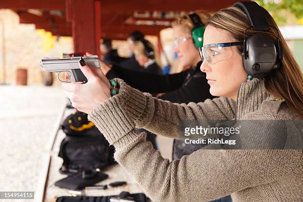 practicing at the shooting range - schietsport stockfoto's en -beelden