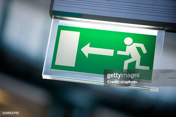 emergency exit sign in white and green - exit sign stock pictures, royalty-free photos & images