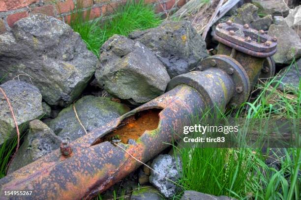 broken cast iron water pipe - broken pipe stockfoto's en -beelden