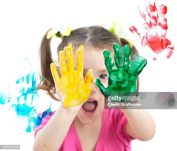 blonde little girl painting with colours on window - paint handprint stock pictures, royalty-free photos & images