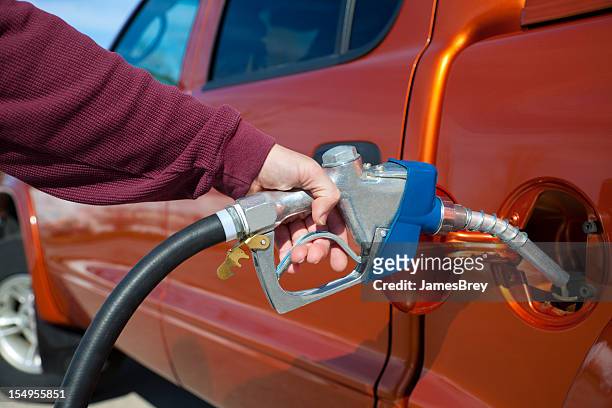 pumping expensive gasoline into gas tank - magenta car stock pictures, royalty-free photos & images