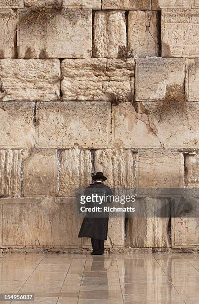 jewish man praying on the wailing wall in jerusalem - jerusalem stock pictures, royalty-free photos & images
