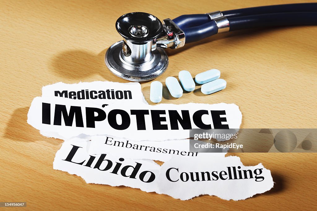 Impotence-related headlines, stethoscope and medication on doctor's desk