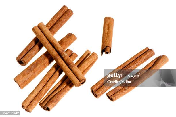 group of cinnamon sticks on white background - cinnamon stock pictures, royalty-free photos & images