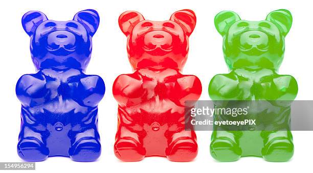 drei bunte gummy bears - gummibär stock-fotos und bilder