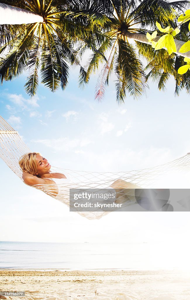 Woman relaxing in a hammock.