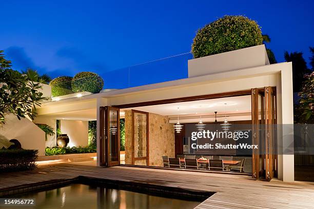 modern villa with a pool - swimming pool night stock pictures, royalty-free photos & images