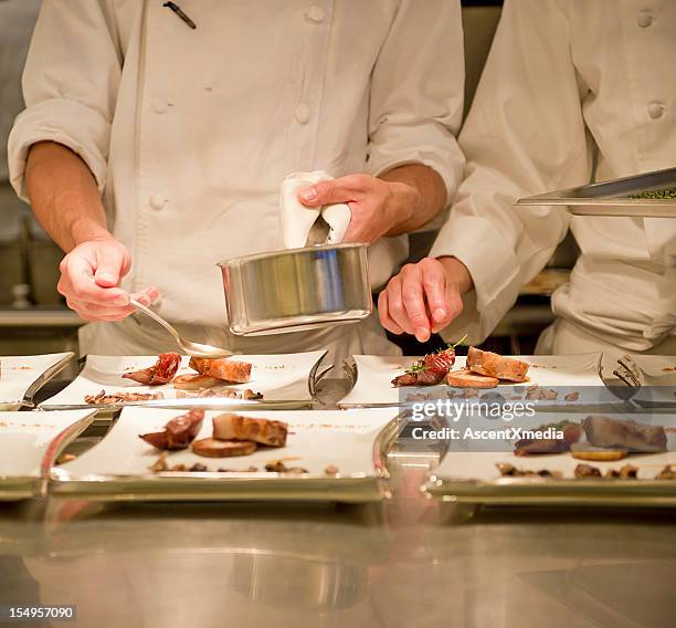 chef fixing appetizers to be delivered - banket stockfoto's en -beelden