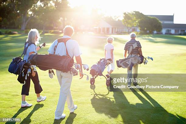 couples returning after a game of golf - golf championship stock pictures, royalty-free photos & images