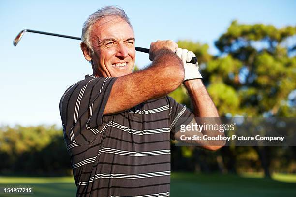 mature golfer swinging - playing golf stock pictures, royalty-free photos & images