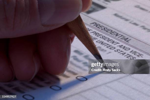 a female voter marks her ballot in presidnetial el - 2012 united states presidential election - election day bildbanksfoton och bilder