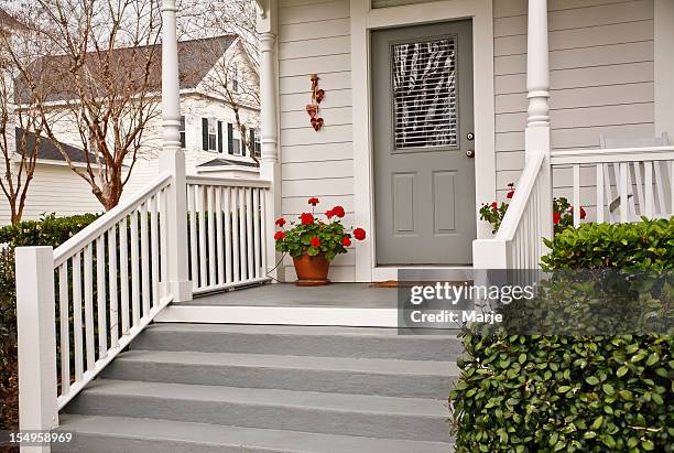 traditional front porch with geraniums - tree area stockfoto's en -beelden