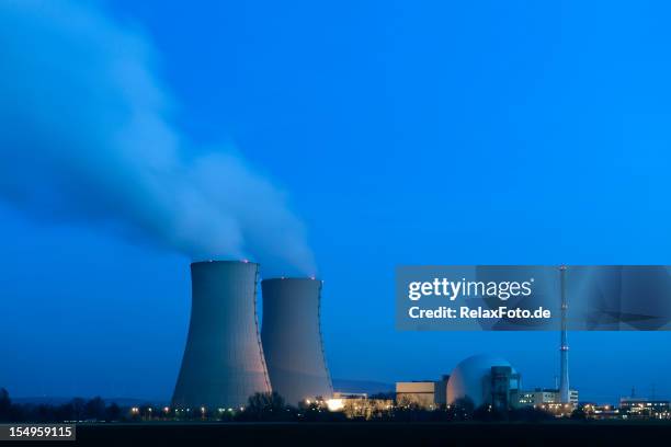 illuminated nuclear power station at night - cooling tower stock pictures, royalty-free photos & images