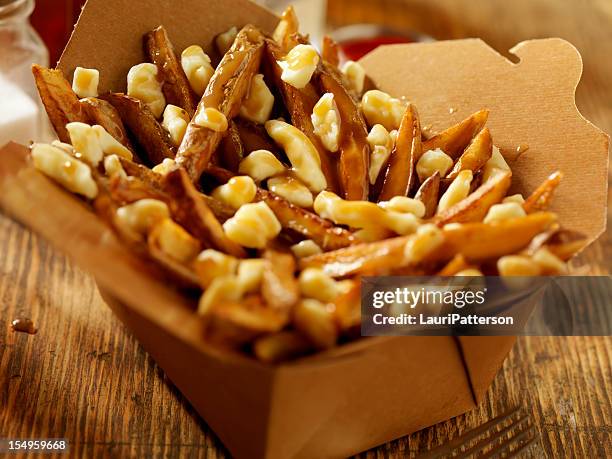 classic french canadian poutine - cheesy fries stock pictures, royalty-free photos & images