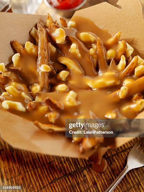 classic french canadian poutine - gravy stock pictures, royalty-free photos & images
