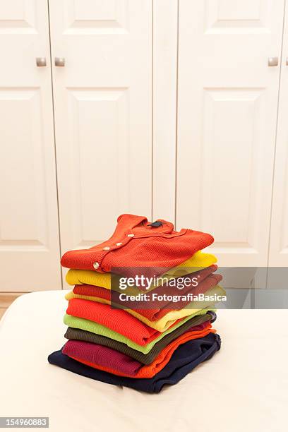 stack of clothing - folded clothes stock pictures, royalty-free photos & images