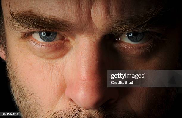stern looking man - frowning stock pictures, royalty-free photos & images