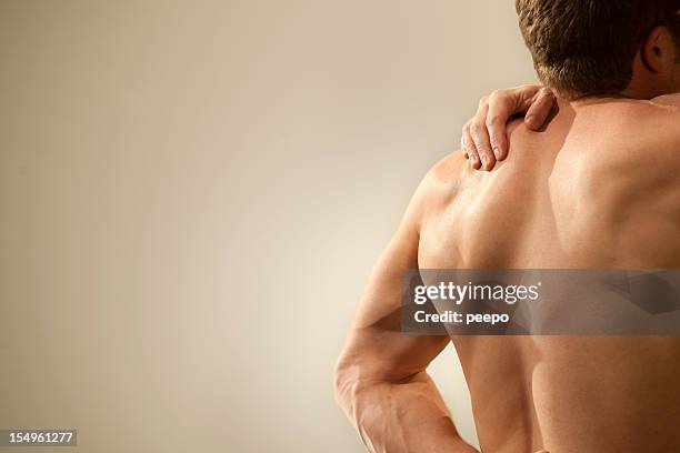 nude man with shoulder pain - muscle cramps stock pictures, royalty-free photos & images