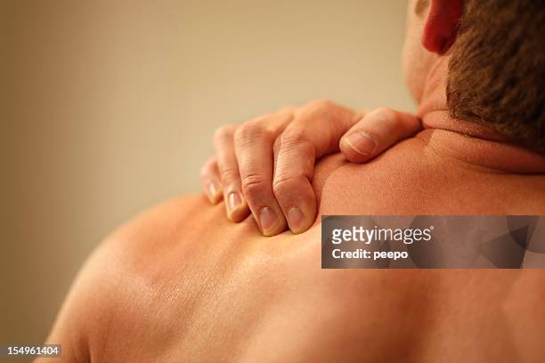 man with shoulder pain - rubbing stock pictures, royalty-free photos & images