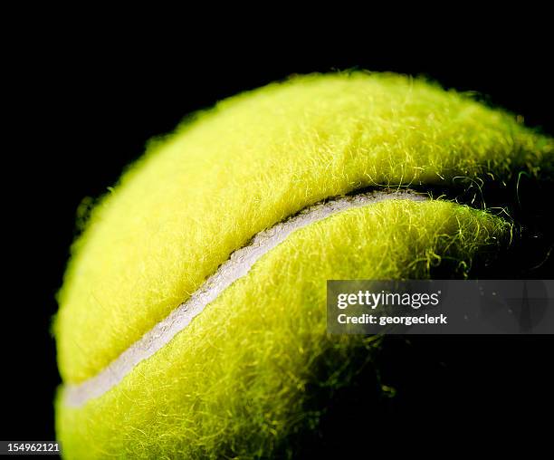 tennis ball macro on black background - tennis ball stock pictures, royalty-free photos & images