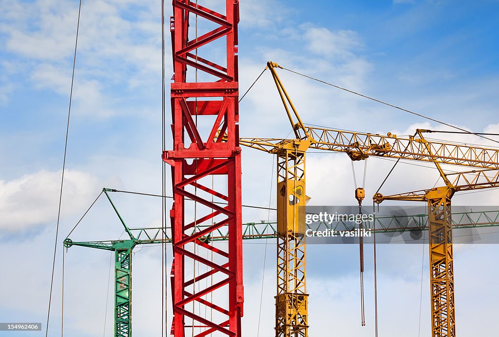 Colorful cranes against blue sky