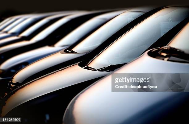 line of cars at sunset - car dealership stockfoto's en -beelden