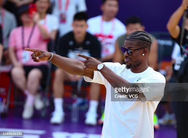 Jimmy Butler, American professional basketball player for the Miami Heat of the National Basketball Association , interacts with fans during his trip...