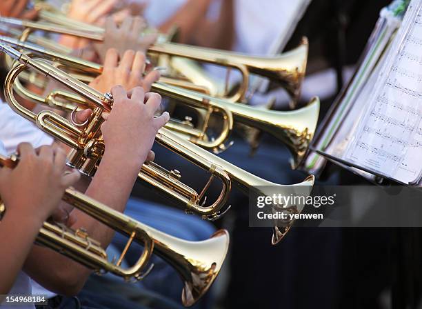 multiple trumpet players reading sheet music - brass band stockfoto's en -beelden